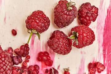 Fragment of a container with ripe red raspberries
