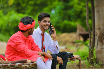 young indian banker or agronomist talking on mobile phone