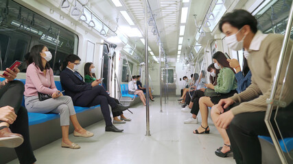 Crowd of people wearing face mask on a crowded public subway train travel . Coronavirus disease or...