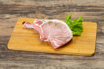 Raw pork bone steak over wooden