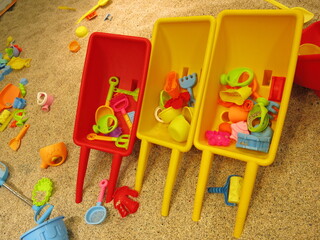 Fototapeta na wymiar there are many colorful trolleys full and all kinds of toys in the Children's bunker for the joyful concept of sandpit 