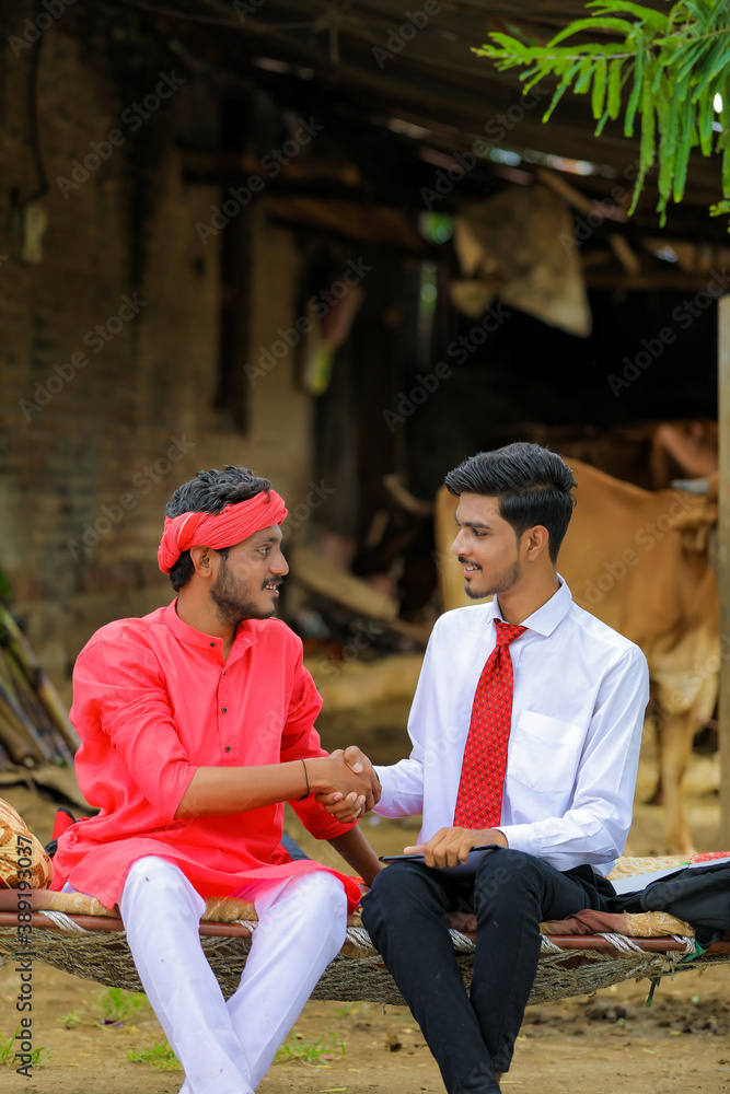 Wall mural indian farmer and banker or agronomist shake hand at home