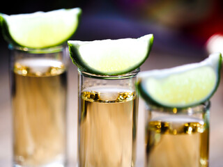Three shots of tequila in tall shot glasses