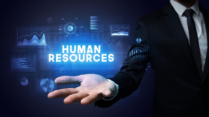 Hand of Businessman holding HUMAN RESOURCES inscription, business success concept