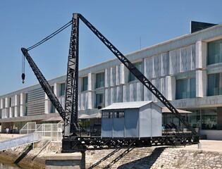 Fototapeta na wymiar Dock house and crane near the Tagus river in Lisbon - Portugal 