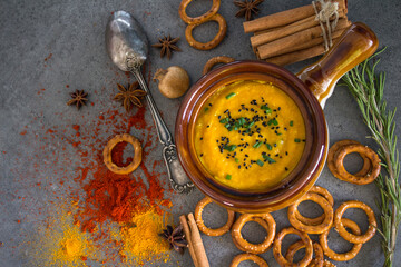 Roasted butternut squash soup with creamy sauce and rosemary. Healthy vegan dinner top view photo. Thanksgiving dinner ideas. 
