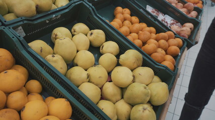 Naklejka na ściany i meble Yellow pears on the market in a basket.