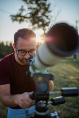 Amateur astronomer looking at the sky with a telescope.