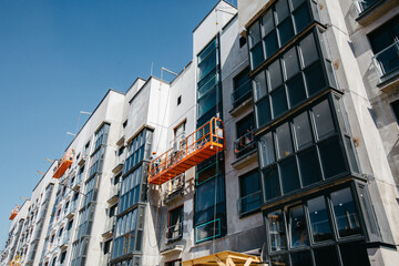 construction cradle with builders at building a house