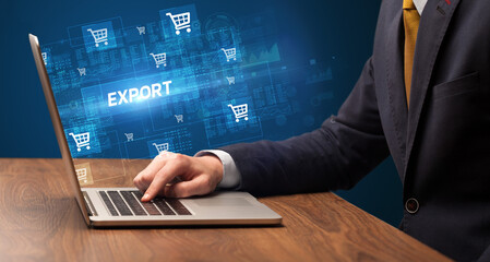 Businessman working on laptop with EXPORT inscription, online shopping concept