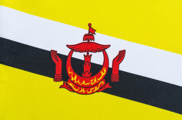 fabric national flag of the state of Brunei Darussalam close-up