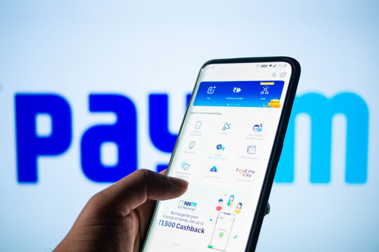 Paytm app logged in on a mobile infront of a white screen with Paytm written