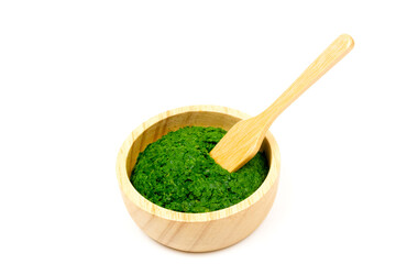 Neem leaf used as ayurvedic medicine on wooden bowl isolated on white background. Neem leaf is an excellent moisturizing and contains various compounds that have insecticidal and medicinal properties.