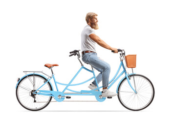 Young man with blond beard and moustaches riding a blue tandem bicycle