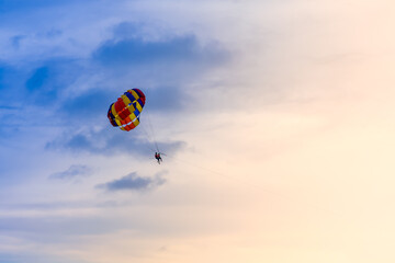 Colorful parachute in the sky on beautiful sunset
