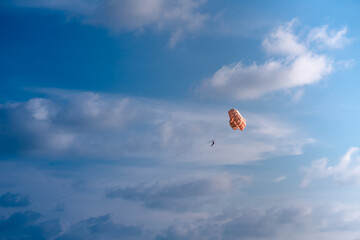 Parasailing in blue sky. Sports, active leisure, travel, vacation concept