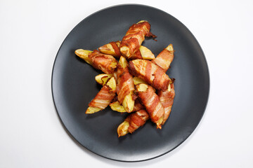 Potatoes with bacon top view on a light background