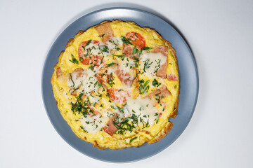 Omelet with cheese and tomatoes top view on a light background
