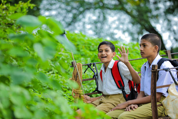 Indian farmer and little school child on bullock cart