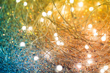 Twinkling Christmas lights on a shiny background. Yellow-green background with LEDs on a wire...