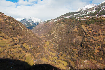 Snowy landscape in pyrenees. Mountains with snow and trees without leaves