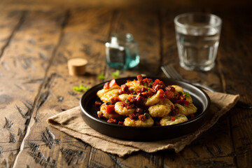 Homemade gnocchi with fried sausage and tomato