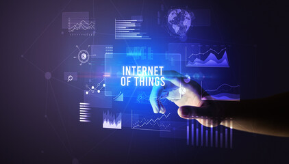 Hand touching INTERNET OF THINGS inscription, new business technology concept