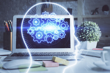 Double exposure of work space with computer and human brain drawing hologram. Brainstorm concept.