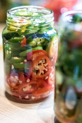 Colourful jalapenos pepper cuts in glasses prepared for preservation/fermentation