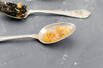 spoon with tea on the table