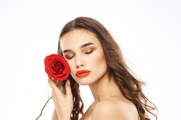 Woman with naked shoulders and red rose evening makeup light background