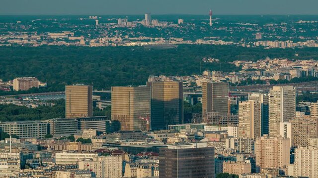 Top view of Paris skyline from above timelapse. Main landmarks of european megapolis with National Library of France at sunset. Bird-eye view from observation deck of Montparnasse tower. Paris, France