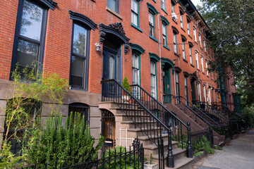 Row of Beautiful Old Brick Homes with Staircases along a Sidewalk in Hamilton Park of Jersey City