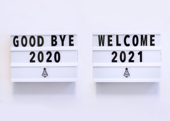 Welcome 2021 and Good Bye 2020 on lightbox flat lay, top view with copy space on white background. New year celebration. Happy New Year 2021 concepts - Image