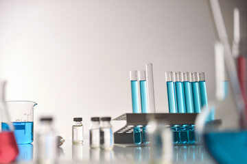 Vaccine vial search concept on table around chemical glassware