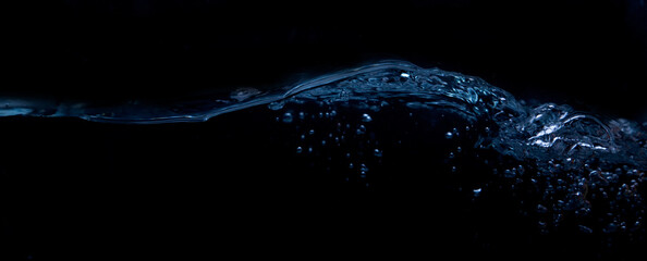 A wave on a black background