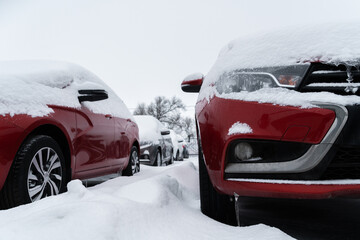 Snow covered parked cars. Winter season	