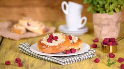 Fresh homemade open patties with cottage cheese. Traditional Russian pastry vatrushka, round buns with raspberries.