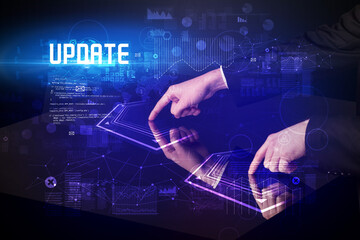 Hand touching digital table with UPDATE inscription, new age security concept