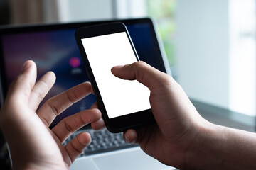 Mockup of man using and touching on blank white screen mobile phone, working in modern office