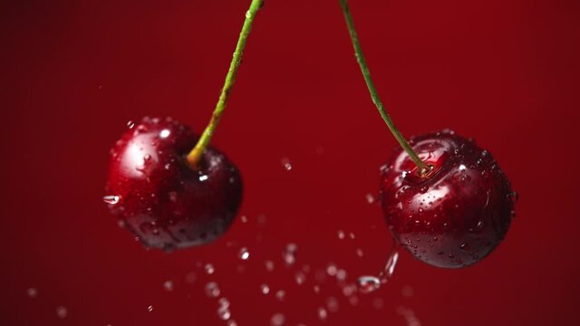 Sweet Cherries with Stems Colliding and Splashing Water Droplets. Shot in 1000fps with Phantom Flex 4K