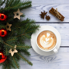 Creative concept holiday celebration photo of christmas tree toys balls decoration with coffee cup on white  wooden background.