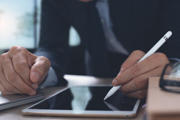 Business man using stylus pen signing on digital tablet during working on office for E-signing or electronic signature concept