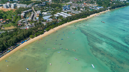 Aerial drone bird's eye view photo Top down of asphalt road near the sea with long tail fishing boats at phuket thailand.