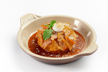 Apple Pie or Tart with caramel, mint crunchy waffles in a bowl on a white background