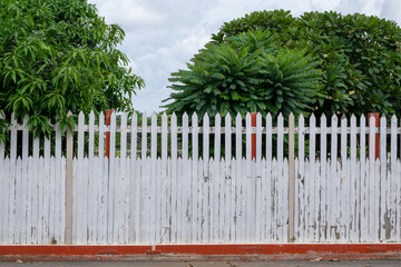 The white picket fence is painted on the bottom edge with red.