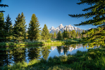 Schwabachers Landing in the early morning in Grand Teton National Park, with mountain reflections on the water creek