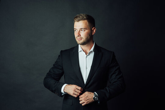 Handsome male businessman with suit posing in a photo studio. Half-length portrait