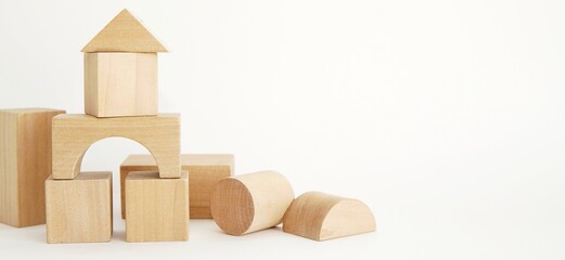 Wooden kids toys, building blocks on white background, banner, space for text.