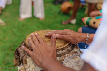Popular Culture of Capoeira - Close up of hands of man playing African percussive drum